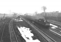 View towards Paisley on 2 April 1969 as a westbound goods runs through the site of Elderslie station behind an EE Type 3, shortly after removal of the platforms.<br><br>[Colin Miller 02/04/1969]
