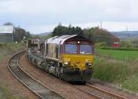 Having just passed the now extinct <i>Cawburn Jct</i> 66245 heads toward the site of Drumshoreland station with the empty <i>Bathgate Cars</i> to Washwood Heath on 13 April 2004<br><br>[James Young 13/04/2004]