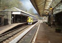 What a gem of a station Hebden Bridge is.  LYR period signage, canopies and replica gas lamps, working toilets, booking office and an excellent station buffet. 158872 stops at the staggered Up platform on a Manchester service.<br><br>[Mark Bartlett 04/04/2009]