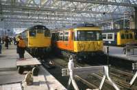 Morning rush hour arrivals at Glasgow Central in April 1985. Featured are Classes 27, 303 (EMU) and 101 (DMU).<br><br>[Mark Dufton /04/1985]
