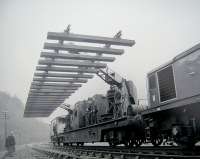 A track panel, located at the meeting point of the Midland and Scottish regions of BR, is lifted from the up line near  Riddings Junction on 8 January 1969, marking the end of the Waverley route as a through main line linking Carlisle and Edinburgh. The lifting <I>'ceremony'</I> had been arranged by BR following a media call, presumably to emphasise the point that their battle to close the line had finally been won. Nearest the camera is local man Willie Whittaker, doubtless  feeling more than a tinge of sadness as he observes the proceedings, hand on hip. The hand would likely be transferred from hip to pint pot that night in <I>The Riverside</I> back in Canonbie. [Editors note: Photograph copyright Cumbrian Newspapers Ltd - reproduced here with their kind permission. Thanks to Gary Straiton for obtaining the image and clearance, also Bruce McCartney for providing additional caption details.] <br>
<br><br>[Gary Straiton (Courtesy Cumbrian Newspapers Ltd) 08/01/1969]