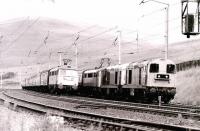 For reasons unknown, a pair of EE Type 1s attached to the front of a WCML train in the up loop at Abington in 1980 being passed by another southbound service.<br><br>[Colin Miller //1980]