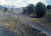 Looking east at Bathgate Upper. Bathgate Goods Yard was off to the left - a Landrover on a car train can be seen in the yard on the left. A new road had been built on the level which severed the old station from the still open line.<br><br>[Ewan Crawford //1988]