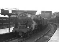 Royal Scot 46148 <I>The Manchester Regiment</I> stands at the south end of a wet Carlisle station on 22 August 1964 with the 7.11pm stopping train for Warrington Bank Quay.<br><br>[K A Gray 22/08/1964]
