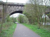 Although the Lune Aqueduct of the Lancaster Canal was built (in 1797) more than 40 years before the railway one of its five 70' arches was able to accomodate the double track Wennington line. Later, Lancaster Power Station was built here and a third line under the arch served coal sidings operated by fireless locomotives [See image 27588] until closure in 1981. View down the trackbed cycle path towards Lancaster Green Ayre.<br><br>[Mark Bartlett 24/04/2009]