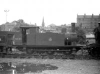 Scene in the sidings alongside Dundee West mineral yard in July 1959 with class J69 no 68535 one of several <I>stored</I> locomotives present. In the background stands the former Seabraes Sawmill of Thos Winton Ltd located at no 16 Roseangle.<br><br>[Robin Barbour Collection (Courtesy Bruce McCartney) 30/07/1959]