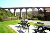 Looking east along the Esk towards Whitby from the south bank in April 2009 with the Scarborough and Whitby Railway's Larpool Viaduct dominating the scene. The Whitby - Grosmont route still passes below the viaduct (third arch from left) while the steep connecting spur that once ran from Whitby Town to Whitby West Cliff ran through the leftmost arch.<br><br>[John Furnevel 20/04/2009]