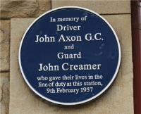 The plaque on the wall of the former station building at Chapel-en-le-Frith commemorating John Axon GC and John Creamer. [Railscot note: On 9 February 1957, driver Axon's freight train was returning from Buxton in the Derbyshire Peak District to his home depot at Edgeley, Stockport, when the steam brake pipe fractured. Despite exposure to scalding steam, he urged his fireman to jump to safety and hung on the outside of the cab as the train picked up speed, reaching 80mph down a long incline. His shouted warning to the signalman at Doveholes enabled a DMU at Chapel-en-le-Frith to be moved to safety but his own life was lost as his engine crashed into the rear of a freight train there. John Creamer, the guard on the second train, also died in the crash. John Axon was posthumously awarded the George Cross.]<br>
<br><br>[John McIntyre 13/05/2009]