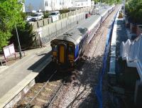 156 450 at the head of a 4-car service to Glasgow Central stands in bright sunshine at Dunlop on 13 May as work progresses alongside on the second platform.<br><br>[Ken Browne 13/05/2009]