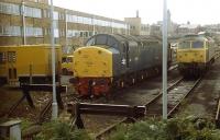 Shortly after being reinstated for Departmental use Class 40 No. D212/40012 <I>Aureol</I>, now renumbered as 97407, sits in Ladywell sidings, Preston alongside an unidentified Class 47. These sidings, to the north east of the station, were swept away when Preston's ring road was extended. The loco was subsequently preserved at the Midland Railway Centre, Butterley. <br><br>[Mark Bartlett //1985]