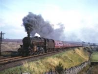 Black 5 no 44700 with an 11-coach train and banker near Shap Wells in the 1960s heading for the summit. Today, part of the background is occupied by the M6 Motorway.<br><br>[Robin Barbour Collection (Courtesy Bruce McCartney) //]