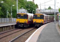 Motherwell bound 318250 and Milngavie bound 318270 await departure from Hamilton West on 27 May.<br>
<br><br>[John Steven 27/05/2009]
