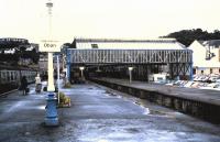 Passengers arrive at Oban in August 1985 alongside the redundant trainshed with its trackless platforms.  One of the passengers seem to trialling the prototype wheeled suitcase (and I let her go).<br>
<br><br>[David Panton /08/1985]