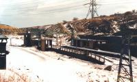 The remains of Dunford Bridge Station, standing at the east end of the 3 mile long tunnel on the closed Woodhead route, pictured following a snowfall in February 1988. View is east, with masts having been removed along the trackbed towards Penistone.<br><br>[David Pesterfield 10/02/1988]