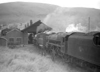 Eastfield Black 5 no 44970 at a busy Fort William shed in 1960. The locomotive in front is 76001, which was a Motherwell engine prior to its transfer to Fort William and became known locally as <i>The Doodlebug</i>. On the far left is the 'cleaners stand' and the building attached to the shed is the fitting shop. [With thanks to John Cameron for additional information.]<br><br>[Robin Barbour Collection (Courtesy Bruce McCartney) 30/08/1960]