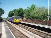 Not to be confused with Mill Hill near Blackburn, this is <I>Mills Hill</I> between Manchester Victoria and Rochdale. The station was built in 1985 to serve an area on the outskirts of Middleton. Like many other Greater Manchester stations built around that time it is of basic wooden construction with shelters. Mills Hill enjoys a half hourly service in each direction and here, looking towards Rochdale, 142062 calls on its way to Manchester.<br><br>[Mark Bartlett 01/06/2009]