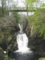 NBR West Highland Line across the A82 from The Falls of Falloch. Bridge over stream.<br><br>[Alistair MacKenzie 28/04/2009]