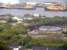 Looking North to the viaduct in the James Watt Dock. This runs off the bridge crossing the Port Glasgow Road (see image 15506, 21461 and 15533). This took the line from the Ladyburn sidings, in amongst the trees to the bottom left, into the James Watt Dock's sidings and United Molasses terminal.<br><br>[Graham Morgan 23/05/2009]