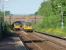 The former Huncoat Colliery access bridge, just beyond Huncoat's platforms, sees two Pacers cross while rostered on East Lancs line services. In my early years, until 1964, I lived opposite the colliery entrance and remember WD 2-8-0s clanking under this bridge on coal trains and NCB liveried AEC 8 wheel lorries growling over it loaded with coal.<br><br>[Mark Bartlett 01/06/2009]