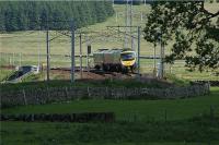 A northbound First TransPennine Express 185 rounds the curve approaching Elvanfoot on 1 June 2009. The photograph is taken from near the bottom of Station Road with the station site off to the left.<br><br>[John McIntyre 01/06/2009]