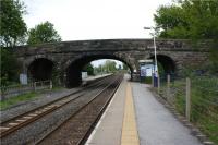 The staggered platforms at Long Preston looking towards Skipton on 17 May 2009. The public access from the road to the northbound platform is on this side of the road bridge. There is a narrow section of platform under the bridge to access the platform shelter at the far end. There is a notice warning pasengers not to stand on this section of platform as trains approach. <br><br>[John McIntyre 17/05/2009]