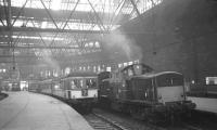 Scene at Princes Street station on 3 September 1965 with a DMU preparing to leave platform 4 and a Clayton ready to take the 2.5pm to Manchester as far as Carstairs.<br><br>[K A Gray 03/09/1965]