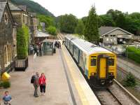 The 1620 service from Llandudno, formed by Arriva Trains Wales unit 150264, drops a large contingent of passengers at Betws-y-Coed on the Conwy Valley line on 12 June 2009. The train will continue from here as the 1701 to Blaenau Ffestiniog. On the right is part of the Conwy Valley Railway Museum, built on the site of the old goods yard. [The name Betws-y-Coed, which translates as <I>Prayer house in the wood</I>, has been spelled with one T since June 1953] <br><br>[David Pesterfield 12/06/2009]