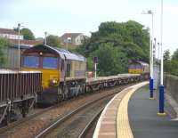 66 173 and 66 047 at either end of a short PW train standing at Kinghorn on Sunday 14 June. Hard against it is the end of a much longer, ballast train.<br><br>[David Panton 14/06/2009]