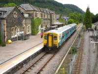 Arriva Wales 150264 on the 17.01 service to Blaenau Ffestiniog at Betws-y-Coed on 12 June. The narrow gauge tracks of the Conwy Valley Railway Museum run alongside the station on the right.<br><br>[David Pesterfield 12/06/2009]