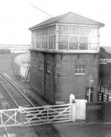 The signal box at Longtown on the Waverley route circa 1962. The view is south from the station footbridge over the level crossing with the single line to Gretna and Mossband Junction branching off to the right. This line was used latterly to give southbound freight traffic off the Waverley a direct route into Kingmoor yard. [Railscot note: <I>Rescued</I> image.]<br><br>[Robin Barbour Collection (Courtesy Bruce McCartney) //1962]