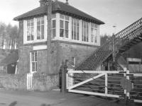 The signal box and level crossing at Newcastleton station on the Waverley route, seen here in the early sixties. A fairly quiet and peaceful location, apart from one particular night in 1969. [See image 18723]   <br><br>[Robin Barbour Collection (Courtesy Bruce McCartney) //]