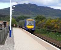 An Inverness - Edinburgh service, formed by 170 422, arrives at Newtonmore on 16 June 2009. The abandoned and overgrown second platform can still be clearly seen.<br><br>[David Panton 16/06/2009]