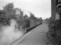 First stop on the West Highland line for the Craigendoran - Arrochar push-pull train was Helensburgh Upper. 67474 is seen leaving the station with the northbound service on 29 July 1959.<br><br>[Robin Barbour Collection (Courtesy Bruce McCartney) 29/07/1959]