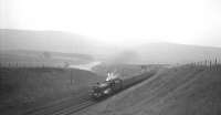 A Stanier <I>Jubilee</I> 4-6-0 running south through the Clyde Valley on the approach to Crawford Viaduct with a special in the 1960s (see image 5699).<br>
<br><br>[K A Gray //]