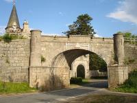 Rail Overbridge and gatehouse to the north of Grantown on Spey, where the former Forres line crosses the A939 road. A private halt was provided here by the Inverness and Perth Junction Railway in 1863  <I>...in acknowledgement of the great facilities given by the Earl of Seafield in the formation of the railway through his estates.</I><br><br>[David Pesterfield 26/06/2009]