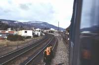 Looking north as a 3 car Metro-Cammell DMU departs southwards from Aviemore before reversing to access the line to Boat of Garten on 07 April 1973. The railway staff with the hi-vis vests will be applying a point clamp before he DMU runs over the facing points.<br><br>[John McIntyre 07/04/1973]