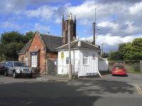 Surviving buildings at the entrance to the former goods yard alongside Dunbar station, photographed on 18 June 2009. The white wooden structure was probably the coal office.<br><br>[David Panton 18/06/2009]