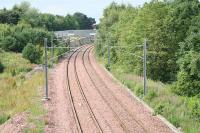 Electrification masts continue <i>heading west</i> near Livingston North on 15 July 2009. <br><br>[James Young 15/07/2009]