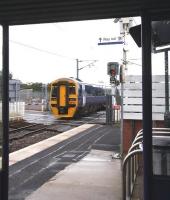 A view from a much needed platform shelter, as 158786 leaves Kingsknowe station in heavy rain on Saturday morning 18 July with the 0825 Edinburgh Waverley - Glasgow Central via Shotts. The 158s are standing in for the regular 156 units on this route, which have been switched to the Glasgow - Girvan <I>Golflink</I> specials during the Open Golf Championship currently being staged at Turnberry. [See image 24635]<br>
<br><br>[John Furnevel 18/07/2009]