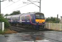 The Saturday morning 0705 Glasgow Central - North Berwick service, formed by unit 322482, runs east over the level crossing into Kingsknowe station on 18 July 2009... and it's still raining... <br><br>[John Furnevel 18/07/2009]