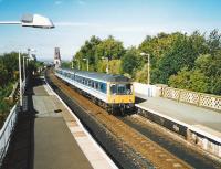 117 311 comes off the Bridge and into Dalmeny with an Edinburgh train in September 1999<br><br>[David Panton /09/1999]