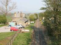 View over Eastgate station (now a private house) in May 2006 looking back along the Weardale branch towards Bishop Auckland. The station, on what was a major mineral branch, lost its passenger service in 1953. The line was cut back from the original Wearhead terminus to the Eastgate Blue Circle cement works (behind camera) by 1968. This part of the line closed in 1993 but, further east, the privately operated Weardale Railway is active.<br><br>[John Furnevel 12/05/2006]