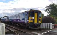 153304 leads an unusual 3-car combination on a Northern service from Carlisle to Whitehaven at Low Mill level crossing Dalston, Cumbria, on 22 July 2009. The unit would appear to have a problem with its lights.<br><br>[Brian Smith 22/07/2009]