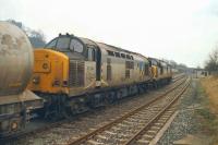 37214 and 37354 head a cement train through Clitheroe south-west towards Blackburn in March 1992. The train had originated from Horrocksford Cement works, accessing the mainline at Horrocksford Jct less than a mile away.<br><br>[John McIntyre 31/03/1992]