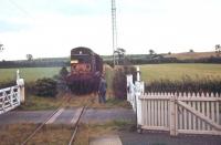 Another shot of what was intended to be the last Langholm/Newcastleton pickup freight in August 1967, with the additional enthusiasts brake van attached. The ensemble is seen here at Gilnockie level crossing on its way from Riddings Junction to Langholm. <br><br>[Bruce McCartney /08/1967]