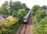 Ten minutes after leaving Perth on 13 June, a southbound First Scotrail DMU en route to Edinburgh runs past the site of Bridge of Earn station.<br><br>[David Forbes 13/06/2009]