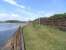 The kickback on the former Pier sidings at Wemyss Bay on 1 June,  with the chimney of the disused Inverkip power station in the distance.<br><br>[David Panton 01/06/2009]