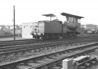 J38 65910 passes the signal box at Cowlairs in October 1964 heading east. A Thornton engine for most of its life, 65910 was withdrawn from there in July of 1966 to be cut up at Campbells of Airdrie 4 months later.<br><br>[Colin Miller /10/1964]