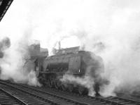 Stanier <I>Coronation</I> Pacific no 46248 <I>City of Leeds</I> getting all steamed up on the centre road at Carlisle waiting to take over the 10.10am Edinburgh Princes Street - Birmingham New Street on 21 December 1963. The Pacific was withdrawn from Crewe North in September of the following year and cut up at Cashmores, Great Bridge, in November 1964.<br><br>[K A Gray /12/1963]