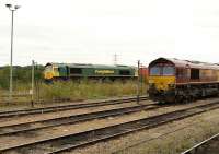 Freightliner 66572 overtakes EWS 66168 alongside Didcot Parkway station on 18 August 2009 as it turns north with a freight on the avoiding line heading towards Oxford.<br><br>[Peter Todd 18/08/2009]